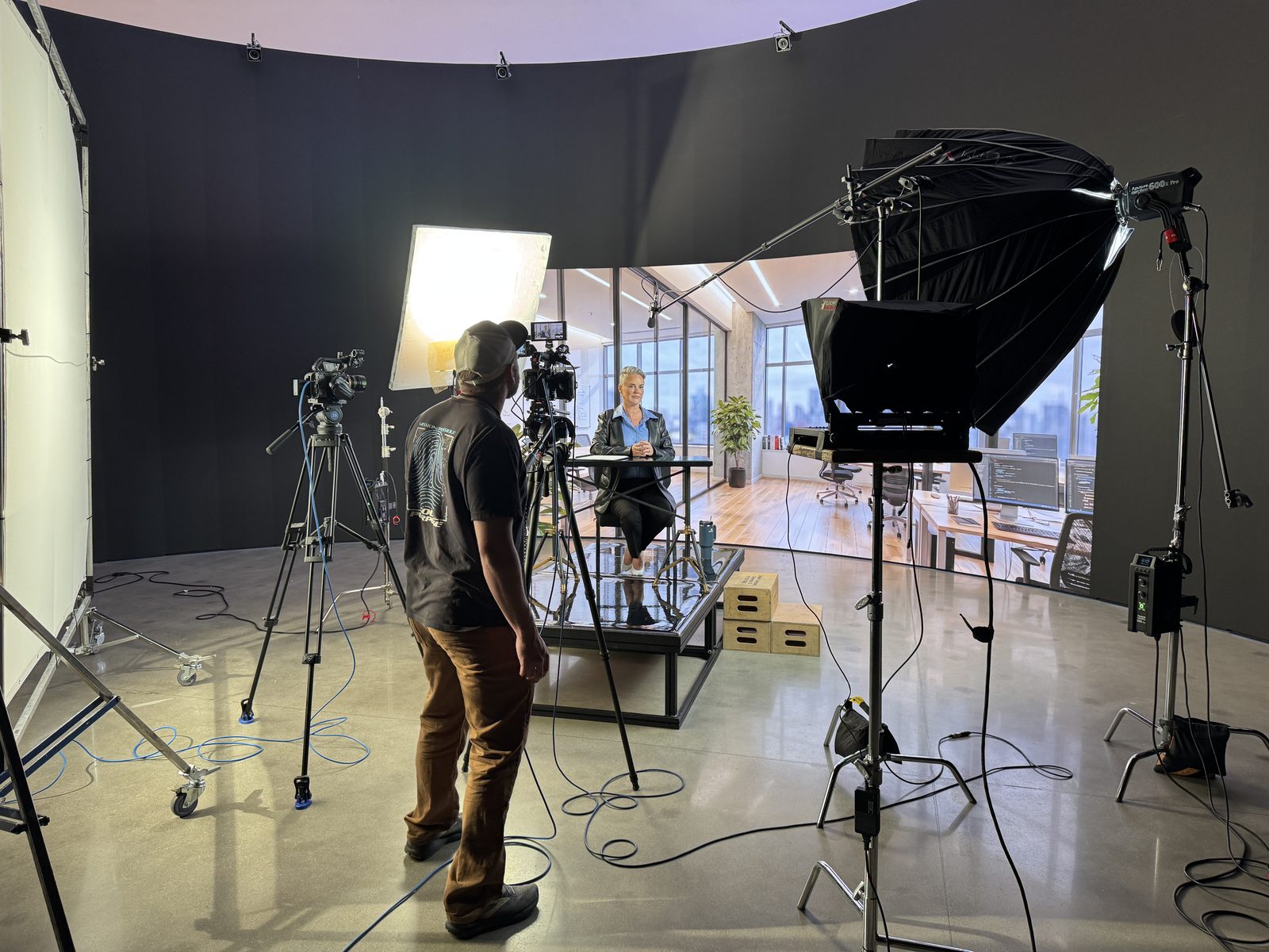 Virtual production shoot on a large LED wall with teleprompter and full lighting rig